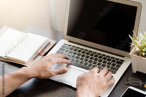 businessman working on laptop in room.