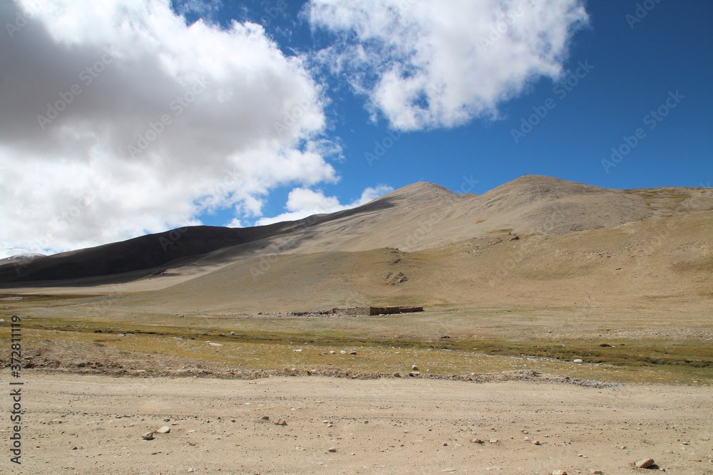 View of the mountains and dramatic sky near Tingri on the way to Everest Base Camp, Tibet, China View of the mountains and dramatic sky near Tingri on the way to Everest Base Camp, Tibet, China