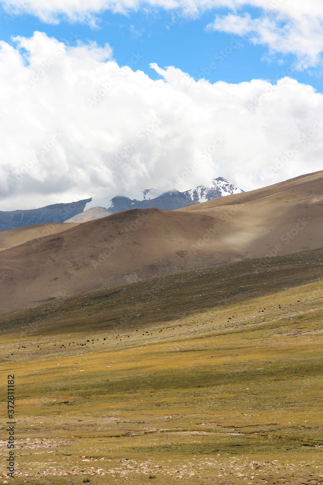 View of the mountains and dramatic sky near Tingri on the way to Everest Base Camp, Tibet, China View of the mountains and dramatic sky near Tingri on the way to Everest Base Camp, Tibet, China