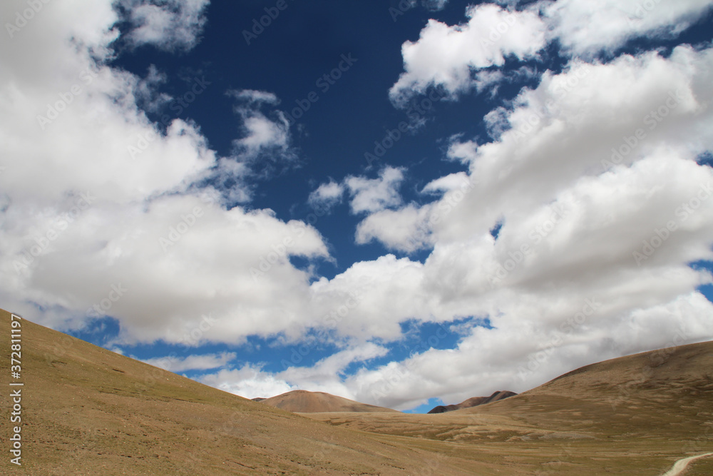 View of the mountains and dramatic sky near Tingri on the way to Everest Base Camp, Tibet, China View of the mountains and dramatic sky near Tingri on the way to Everest Base Camp, Tibet, China