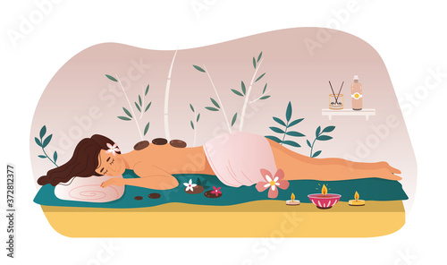 Woman enjoying a treatment at a spa or beauty salon lying on a couch surrounded with flowers, candle and massage stone, colored vector illustration