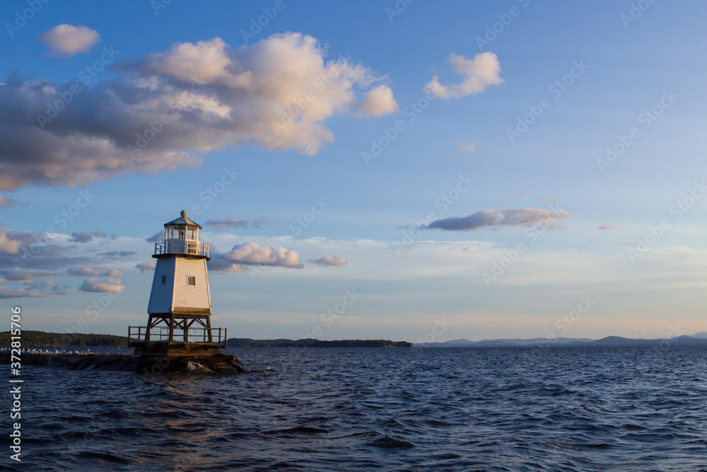Burlington Breakwater Lighthouse just before a sunset with a beautiful blue sky with clouds