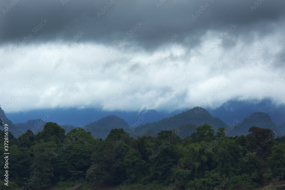 Raining cloud over the mountain and forest near border Thailand and Laos