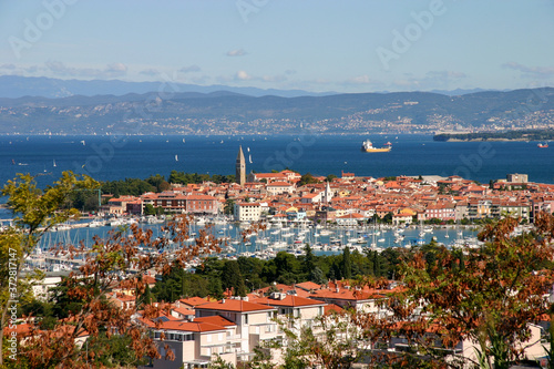 Slovenian beautiful old town and a marina of Izola can be seen in the foreground. Trieste in Italy can be seen in the back ground.