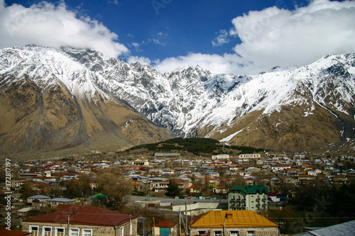 The small town of Stepantsminda (formerly Kazbegi) in Georgia is surrounded by snowcapped the Greater Caucasus Range.