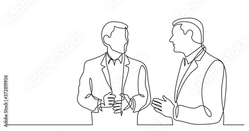 two standing businessmen talking discussing work problems