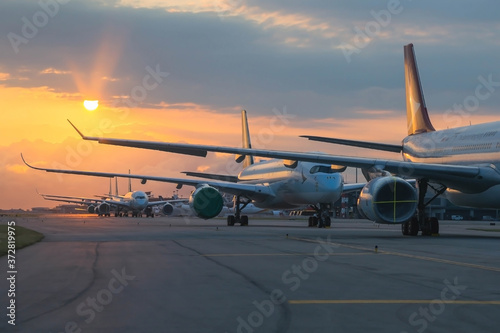 Aircraft are closely line up for long term parking at taxiway of airport due to COVID-19 
