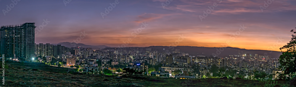 Panorama image of beautiful evening sky in the city with some lights in buildings. Can be used as background.
