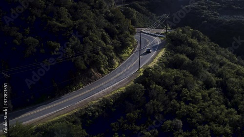 Car driving on edge of canyon with drone photo