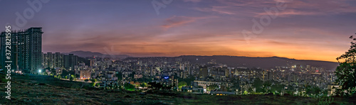 Panorama image of beautiful evening sky in the city with some lights in buildings. Can be used as background.