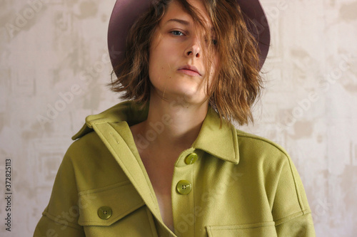 Konstfotografi Girl in a green shirt and a pink hat. Young woman model