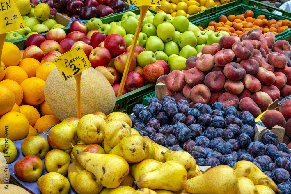 Pears, plums and apples for sale at a market
