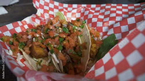 Slow motion clip of fish tacos being put on a table. This was filmed in Tofino at the Tacofino Truck. Filmed on the panasonic gh5 photo