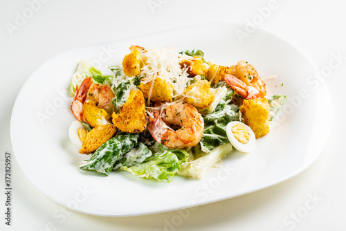 caesar salad with shrimps on the white