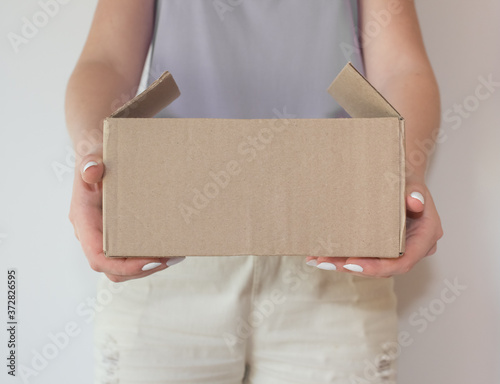  The girl hands the parcel from the online store to the buyer. The concept of delivery of products and other goods