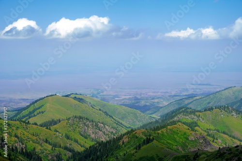 Beautiful view of green mountains. Ketmen or Ketpen mountains gorge and mountain pass. Tourism in Kazakhstan.