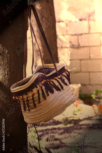 Old fashioned handbag basket hanging on a tree