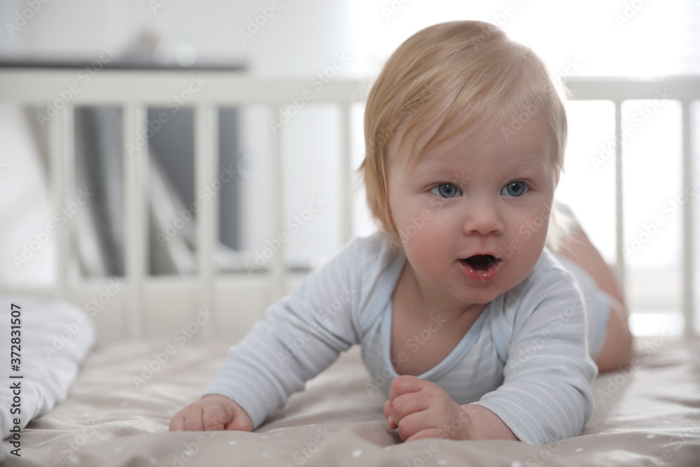 Adorable little baby lying in comfortable crib Adorable little baby lying in comfortable crib