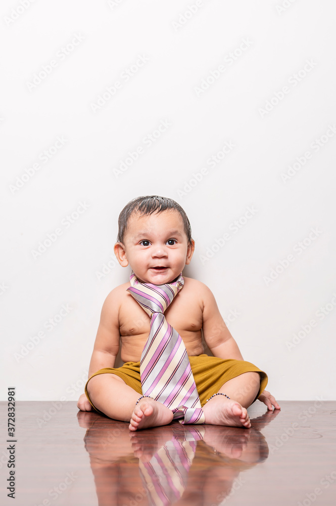Baby in-front of white wall playing with red pillow. Baby in-front of white wall playing with red pillow.
