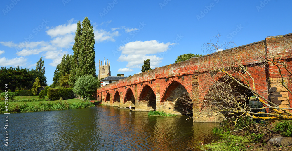 Great Barford Packhorse Bridge and Church Bedfordshire England.