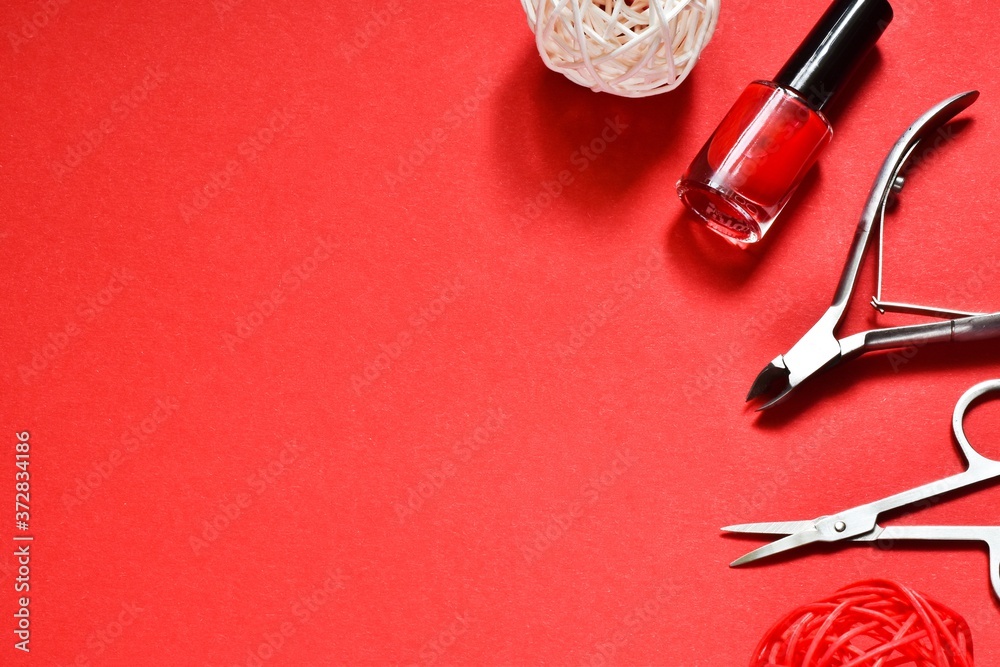 Manicure set and nail polish on a red background. Concept of beauty, manicure. Manicure set and nail polish on a red background. Concept of beauty, manicure.