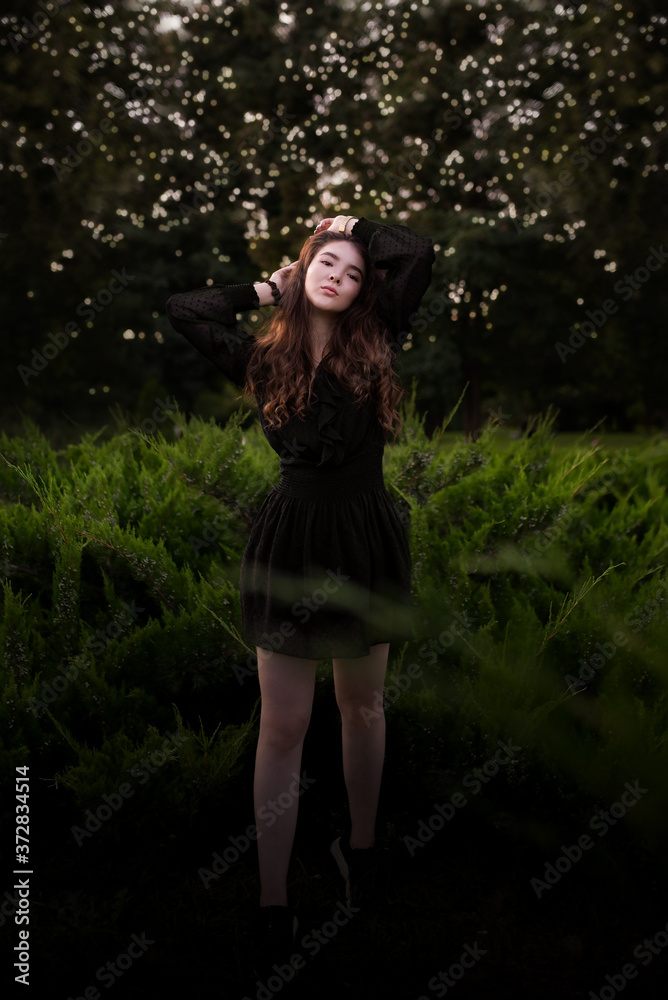 Portrait of a beautiful young girl in the forest at sunset Portrait of a beautiful young girl in the forest at sunset