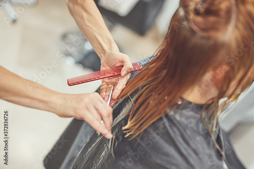 Hair dresser cutting hair in a salon.