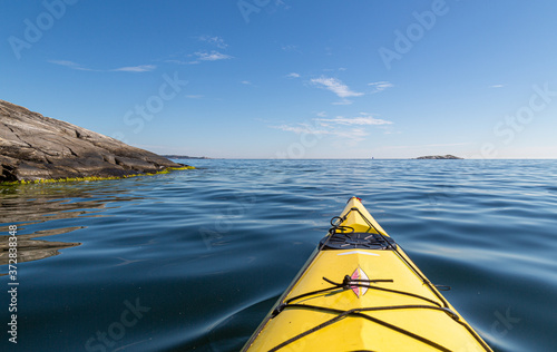 A yellow kayak in the calm sea. Kayaking in archipelago  © Maria