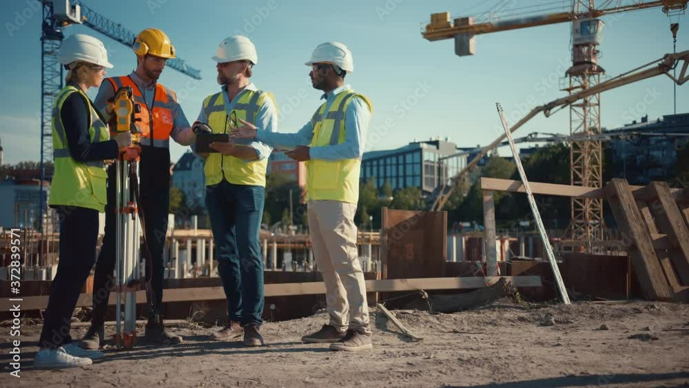 Diverse Team of Specialists Use Tablet Computer on Construction Site. Real Estate Building Project with Civil Engineer, Architect, Business Investor and Surveyor with Theodolite Discussing Plans. Diverse Team of Specialists Use Tablet Computer on Construction Site. Real Estate Building Project with Civil Engineer, Architect, Business Investor and Surveyor with Theodolite Discussing Plans.
