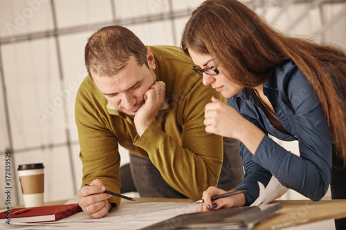 Wall Mural Two architects standing at a desk and discussing a project