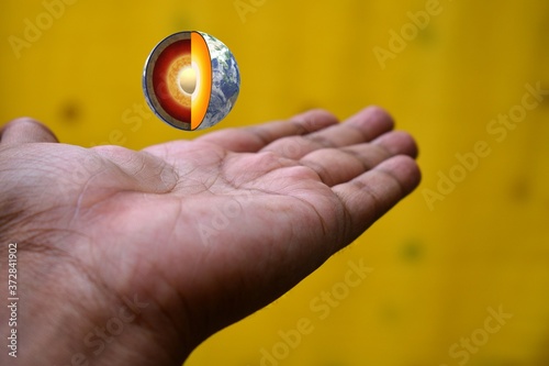 Earths core placed on a man's hand. Save earth and impacts of global warming.