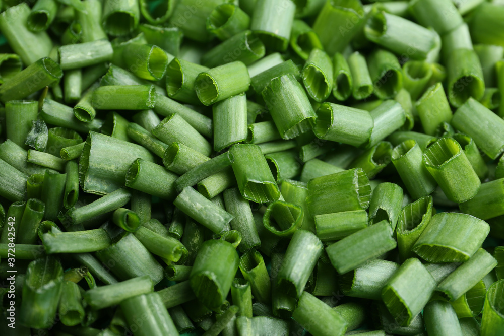 Cut green spring onions as background, closeup Cut green spring onions as background, closeup