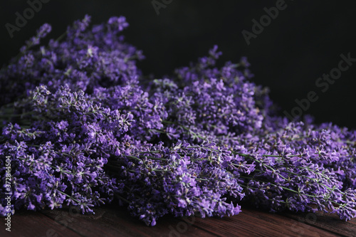 Beautiful fresh lavender flowers on wooden table, closeup