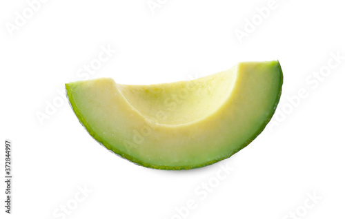 Slice of ripe avocado isolated on white