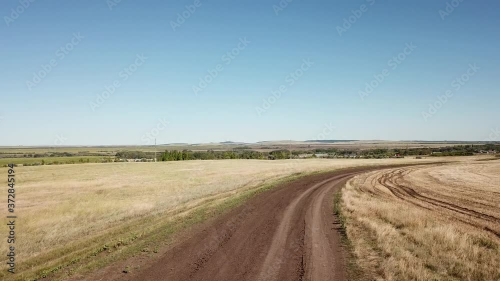 The road through the fields leading to a small village. The road through the fields leading to a small village.