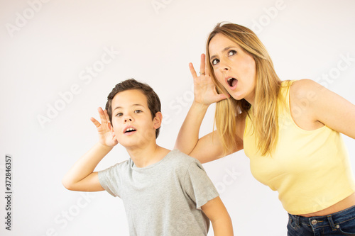 Mother and son making listening gesture