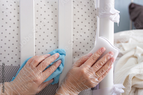 Woman hands in vinyl gloves with sponge and wipe for housekeeping. Cleaning and disinfecting concept