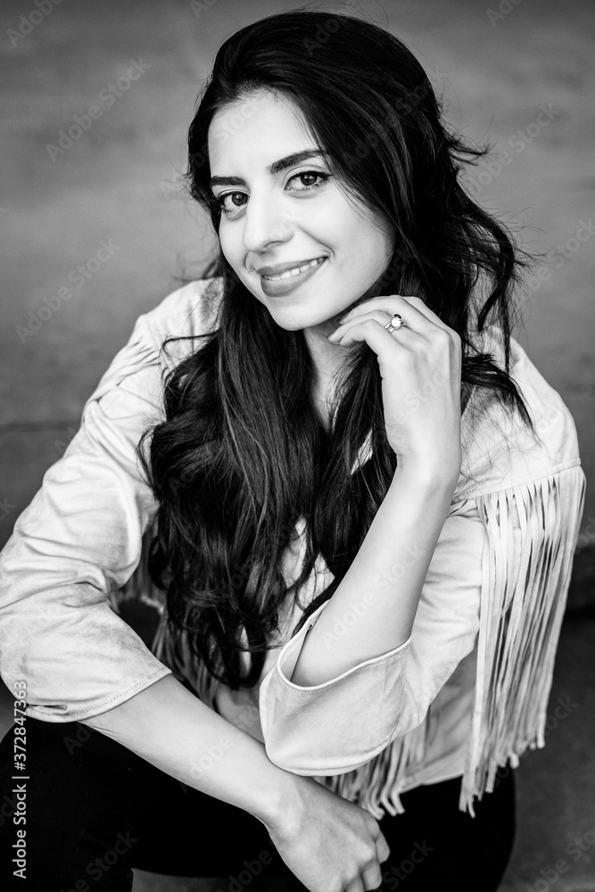 Portrait of smiling attractive woman wearing fashion jacket outdoor