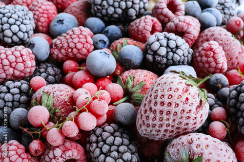 Mix of different frozen tasty berries as background  closeup