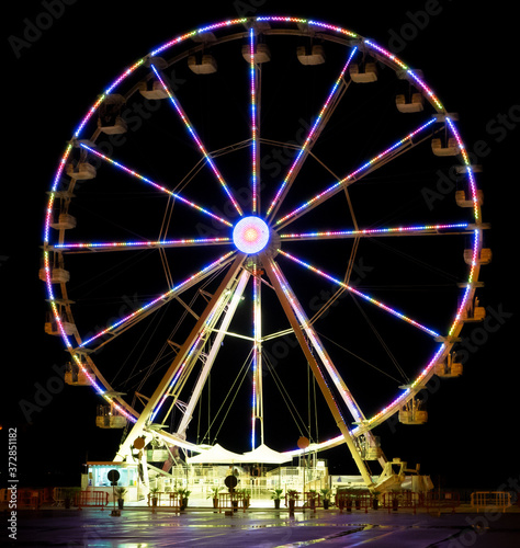 bright ferris wheel lights brighten the night in an amusement park