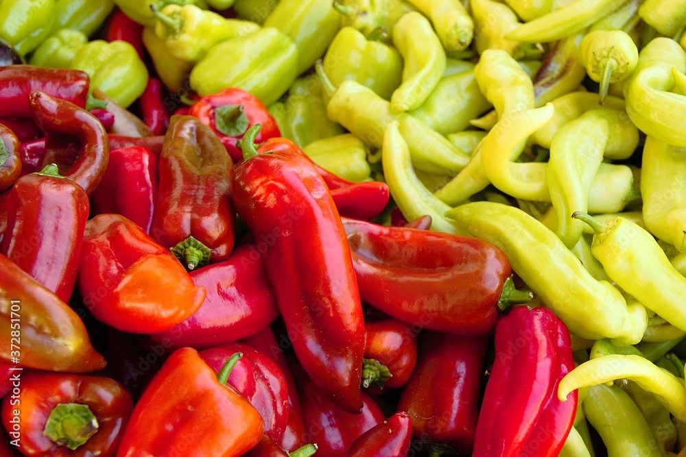 Fresh red and green peppers in a grocery store. Close-up, shallow depth of field