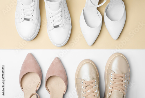 Stylish female shoes and sneakers on color background, flat lay