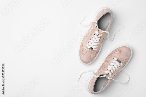 Stylish sneakers on white background, top view