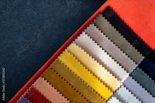 Abstract top down view of colorful velvet samples in warm tones with copy space