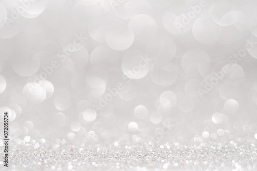 silver Sparkling Lights Festive background with texture. Abstract Christmas twinkled bright bokeh defocused and Falling stars. Winter Card or invitation 