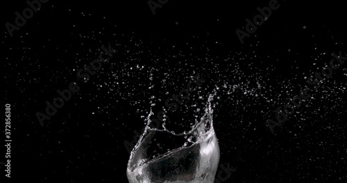 water rising up from the center of a black background.