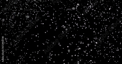 Blizzard of snow at night. It shows the white flakes moving fast on the isolated black background.