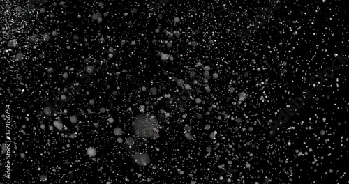 Falling Snowflakes showcases infinite snowflakes falling over a black background. Magical and mysterious.