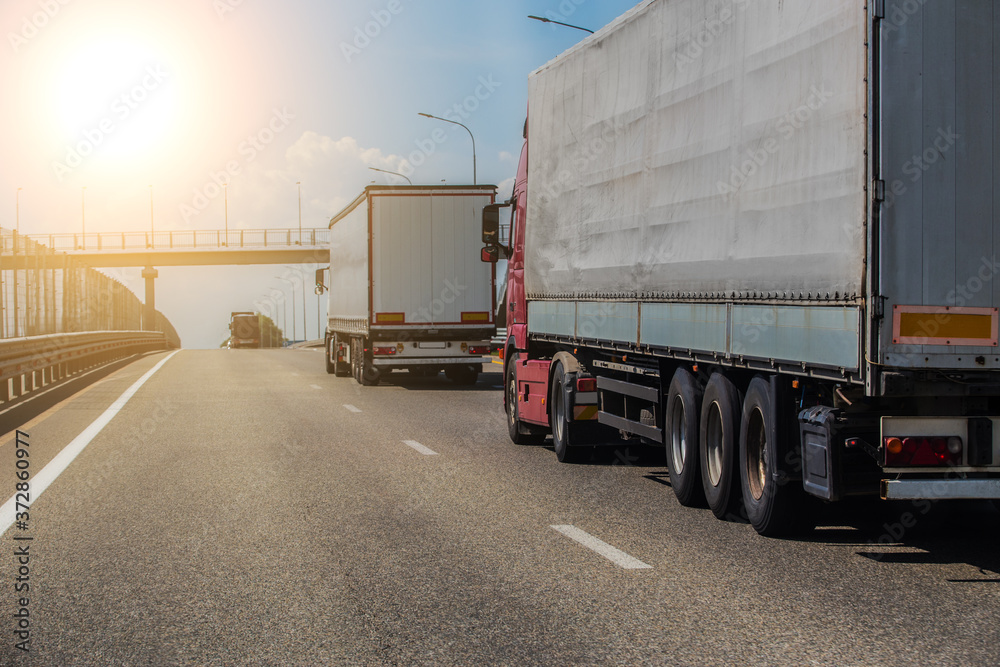 Trucks deliver cargo in opposite directions on a suburban highway Stock ...