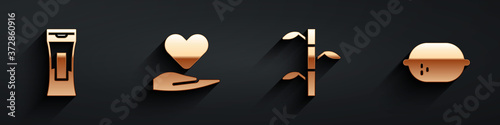 Set Bottle of shampoo, Heart on hand, Bamboo stems with leaves and Lemon icon with long shadow. Vector.
